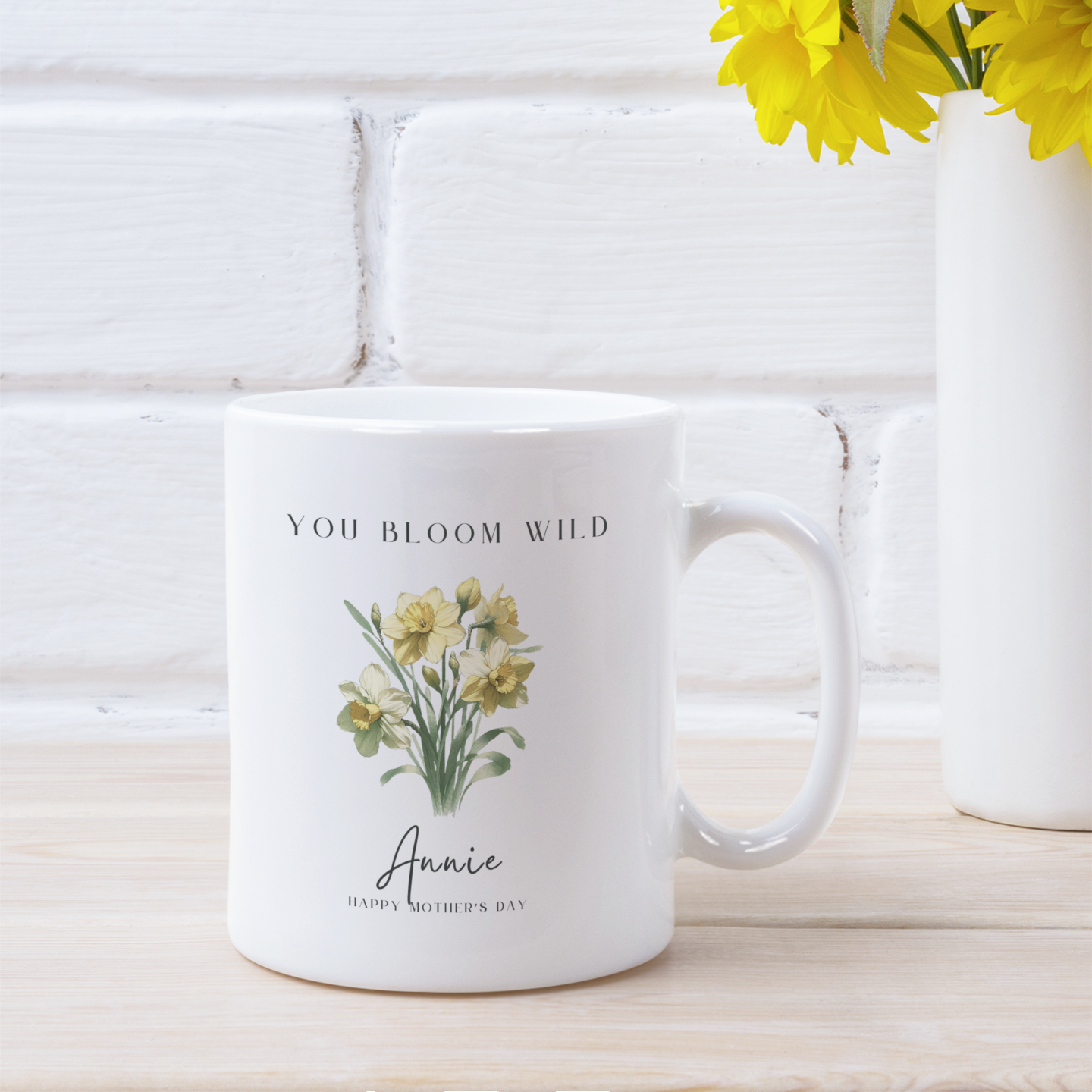 Lifestyle shot of the Personalized Wildflower Birth Month Mother's Day Mug filled with a beverage, highlighting the comfortable C-handle and the perfect size for enjoying a warm drink.