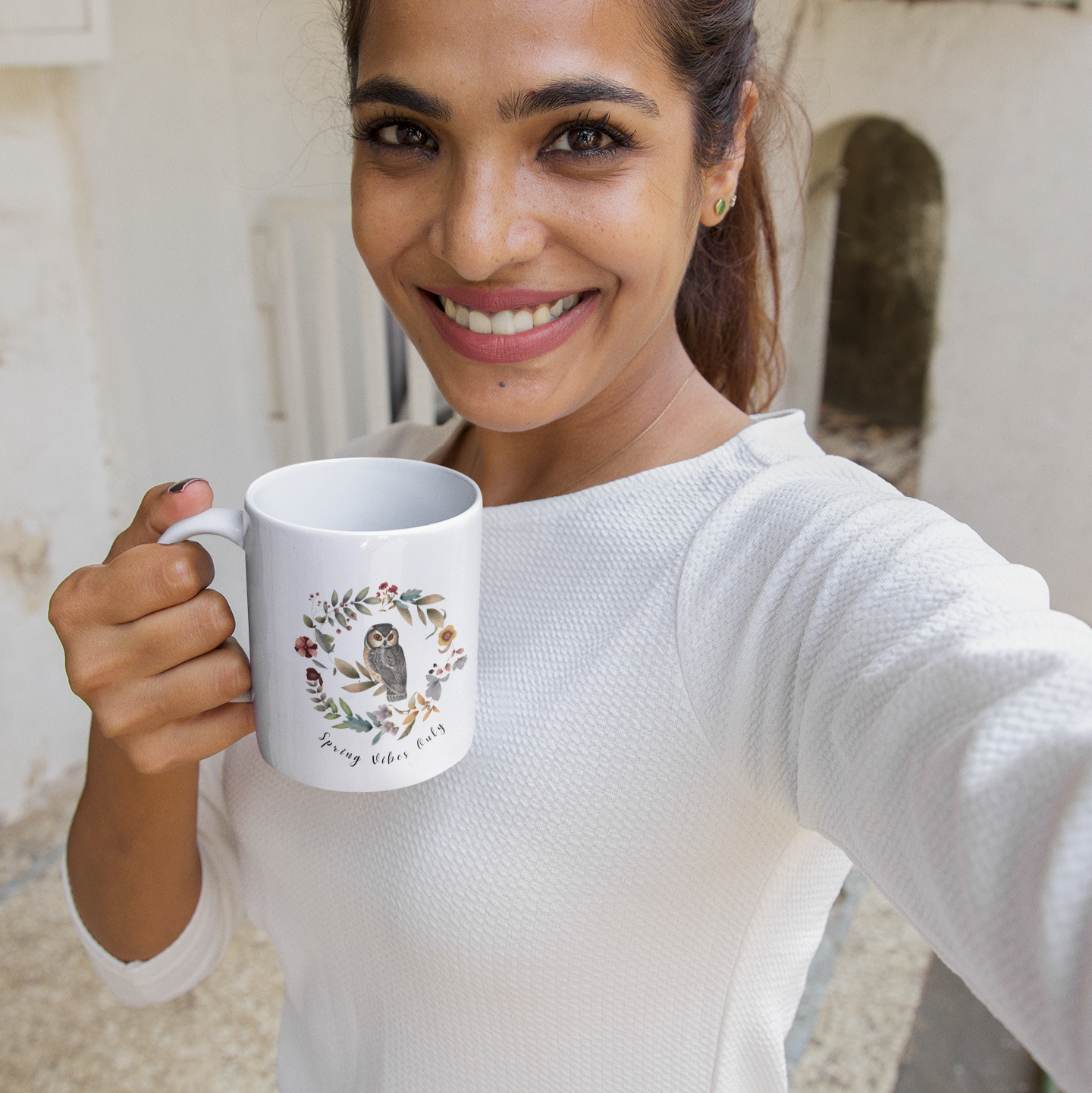 Lifestyle shot of the Wildflower Circle Ceramic Mug filled with a beverage, highlighting the comfortable C-handle and the perfect size for enjoying a warm drink.