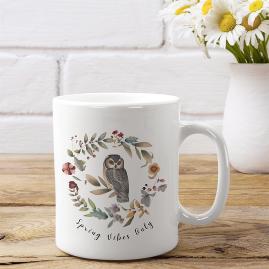 Spring Vibe Only Ceramic Mug featuring a circular design of vibrant wildflowers and owl, on a white background. Available in 11oz and 15oz sizes.