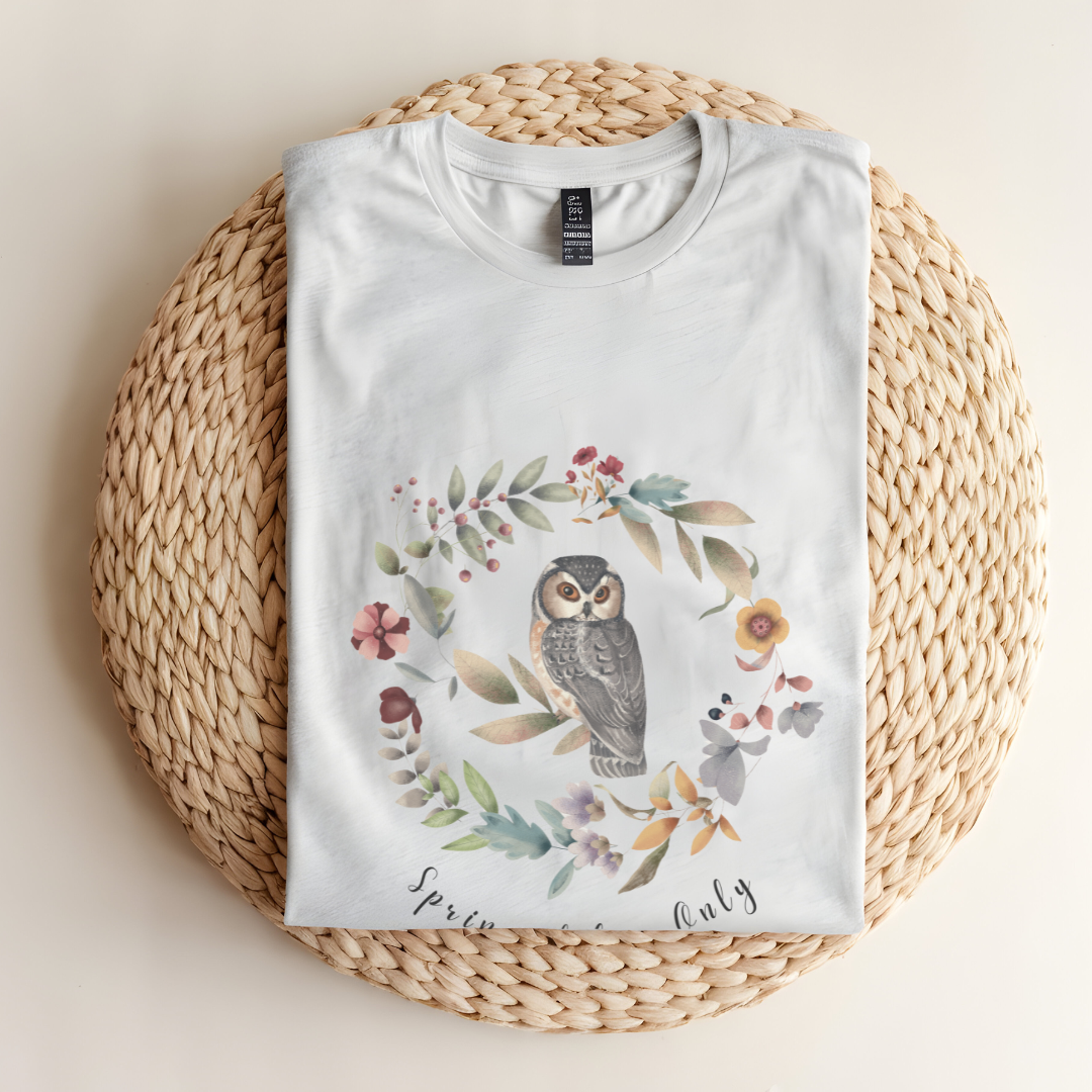 Flat lay of the "Spring Vibes Only" Tee, highlighting the soft, 100% US cotton fabric, classic crew neck, and the adorable owl and floral wreath design. Color Ash