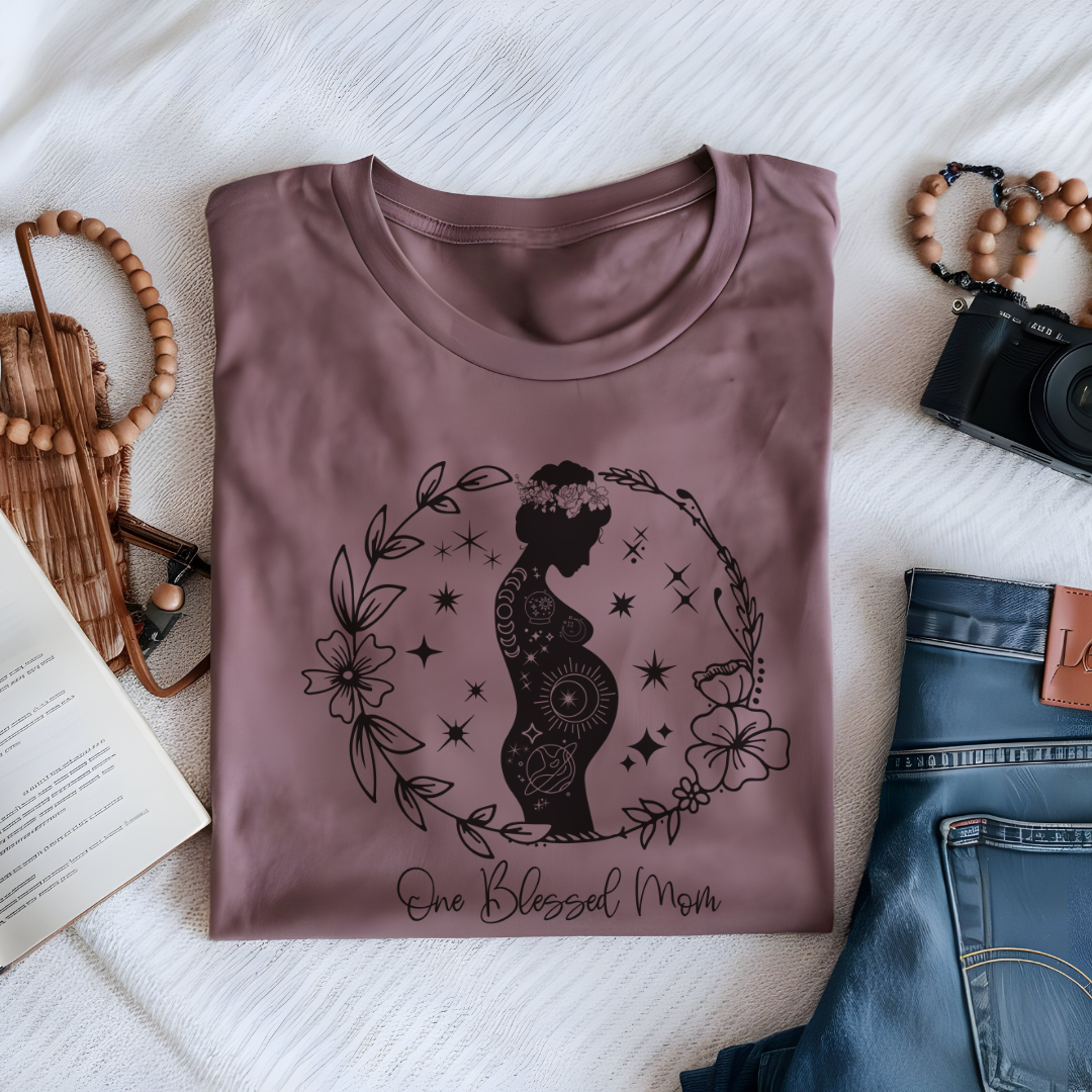 Flat lay of the "One Blessed Mom" T-Shirt, highlighting the soft Airlume cotton fabric and classic crew neckline. Mauve