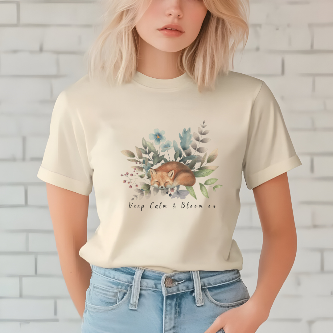 Close-up view of the "Keep Calm & Bloom On" graphic, showcasing the delicate watercolor textures of the fox's fur, the intricate details of the flower petals and leaves, and the whimsical typography of the "Keep Calm & Bloom On" text. Color Natural