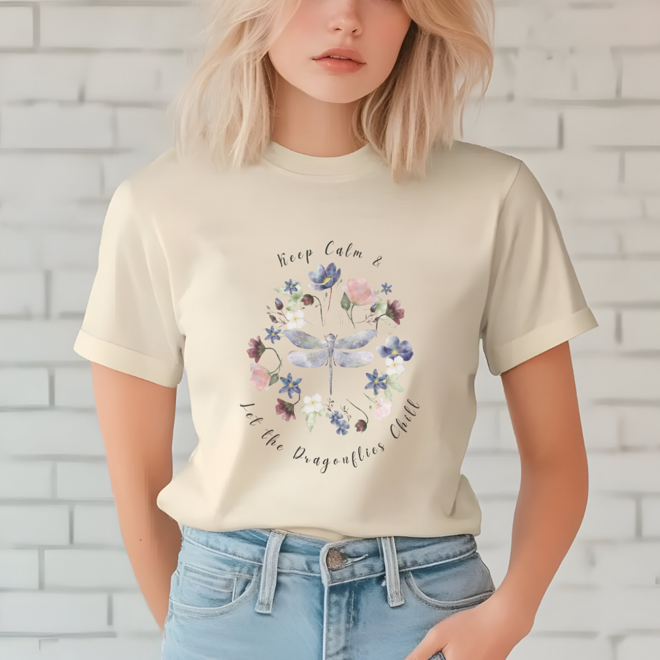 Close-up view of the "Keep Calm & Let the Dragonflies Chill" graphic, showcasing the detailed illustration of the dragonfly with its intricate wings and delicate body, the vibrant colors and textures of the wildflower petals and leaves in the wreath, and the calming typography of the "Keep Calm & Let the Dragonflies Chill" text. Color Natural