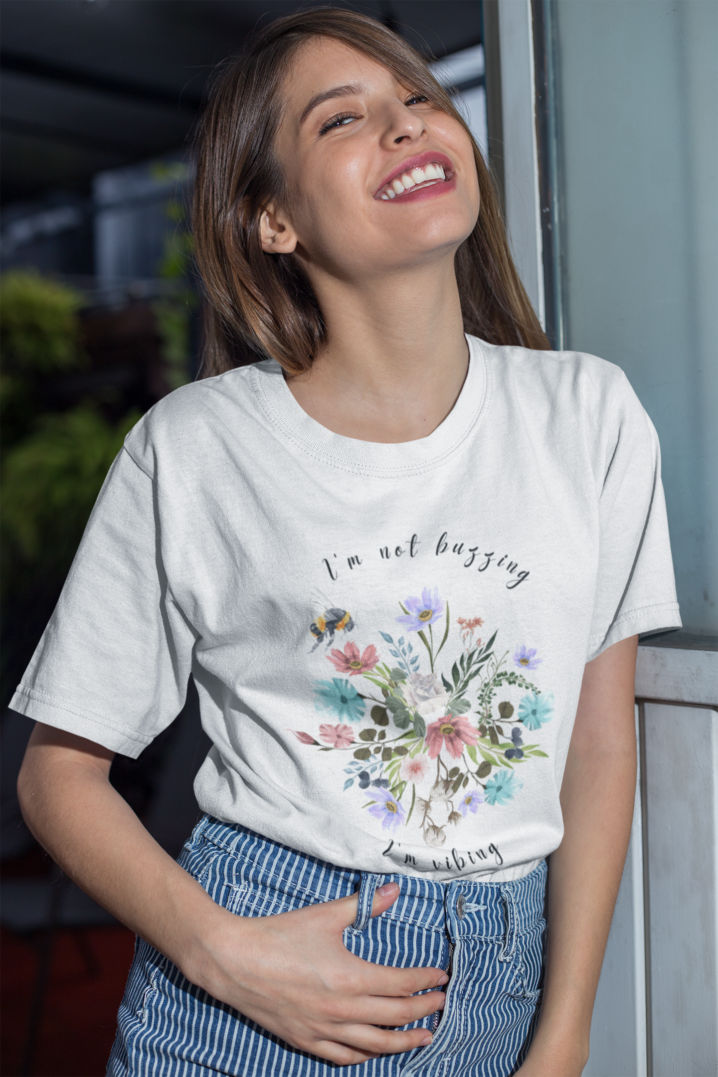 "I'm Not Buzzing" graphic, showcasing the detailed illustration of the bee with its delicate wings and fuzzy body, the intricate details of the wildflower petals and leaves, and the whimsical typography of the "I'm Not Buzzing" and "I'm Vibing" text. Color White