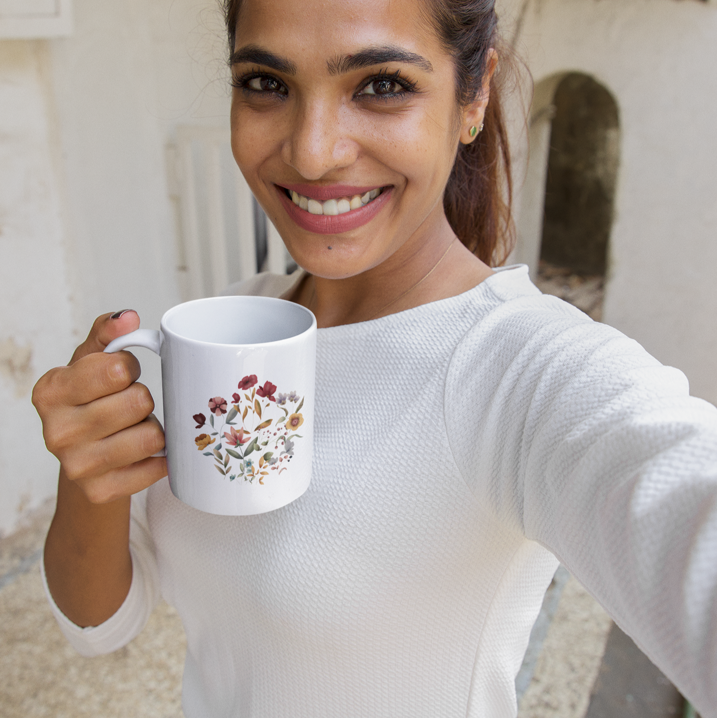 Lifestyle shot of the Wildflowers Circle Ceramic Mug filled with a warm beverage, demonstrating the comfortable C-handle and the perfect size for enjoying tea, coffee, or hot chocolate.