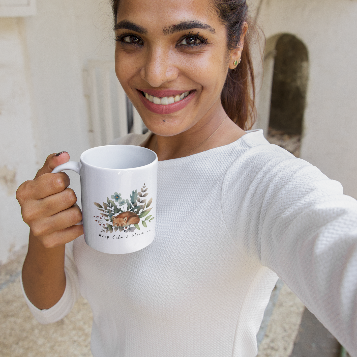 Lifestyle shot of the Wildflower Circle Ceramic Mug filled with a beverage, highlighting the comfortable C-handle and the perfect size for enjoying a warm drink.