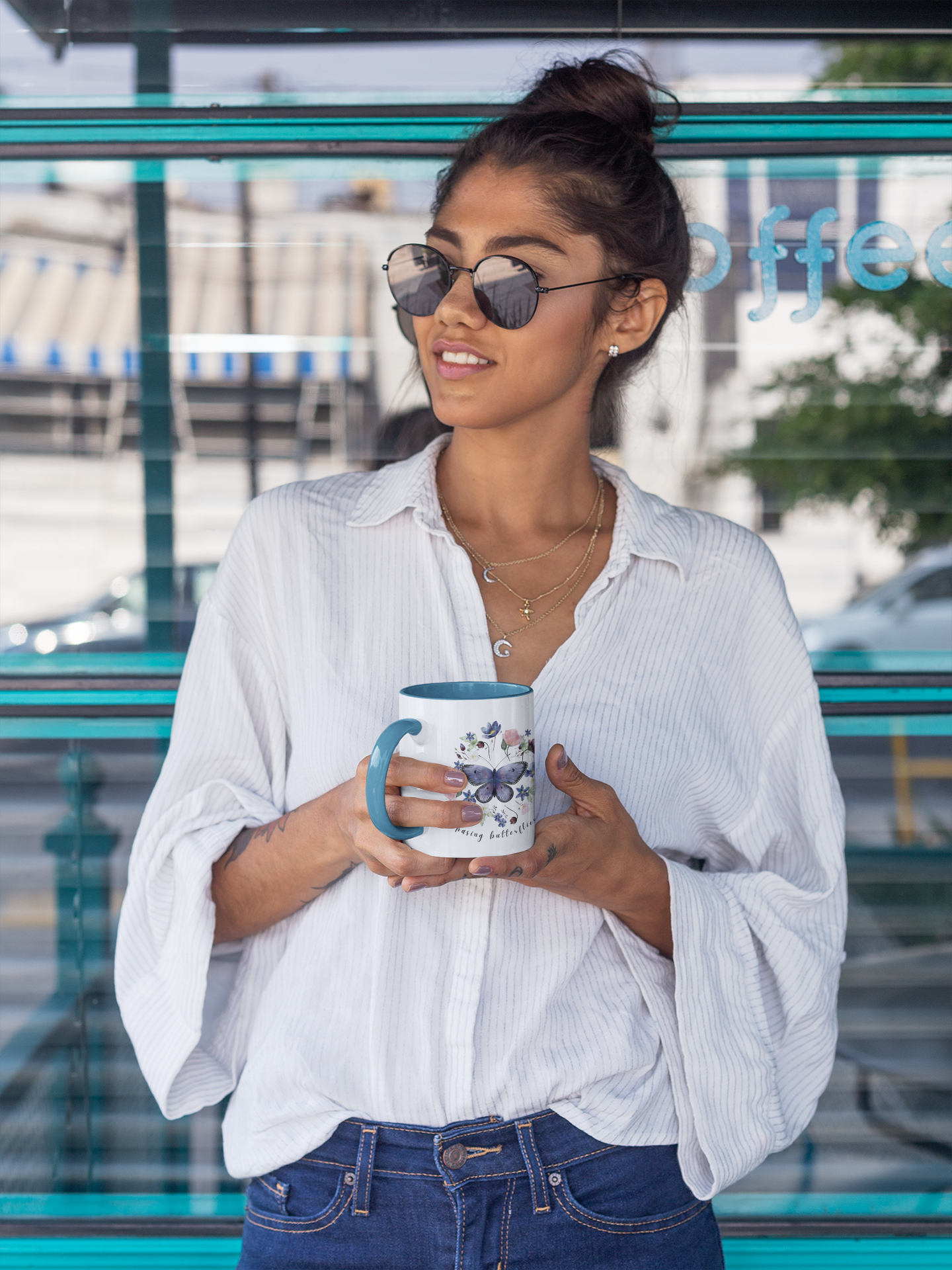  Lifestyle shot of the Butterfly & Wildflower Accent Coffee Mug filled with coffee, showing the comfortable C-shaped handle and the perfect size for enjoying your favorite beverage.