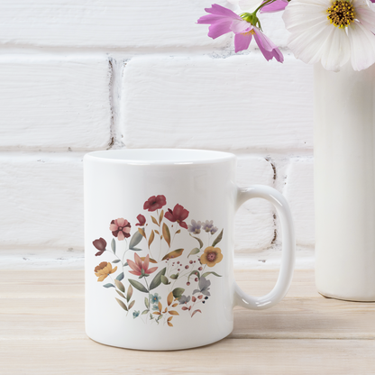 Wildflowers Circle Ceramic Mug, showcasing a vibrant circular arrangement of wildflowers on a white ceramic background. Available in 11oz and 15oz sizes.