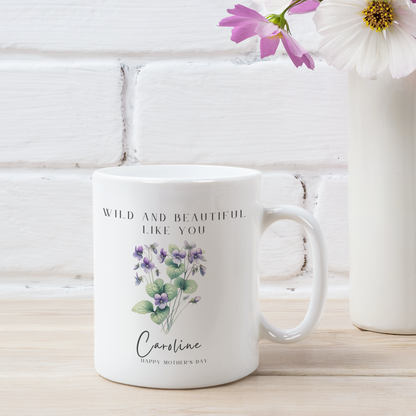 Personalized Wildflower Birth Month Mother's Day Mug, showcasing a sample design with a [Example: May - Lily of the Valley] and a personalized name and message, on a white ceramic mug. Available in 11oz and 15oz.