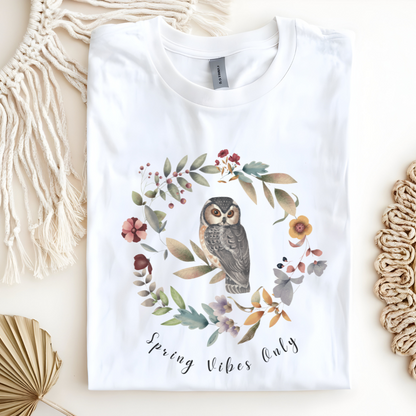 Flat lay of the "Spring Vibes Only" Tee, highlighting the soft, 100% US cotton fabric, classic crew neck, and the adorable owl and floral wreath design.  Color White