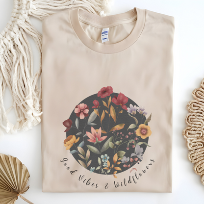 Flat lay of the "Hello Spring: Good Vibes & Wildflowers" Tee, highlighting the soft, 100% US cotton fabric, classic crew neck, and the beautiful botanical floral design.