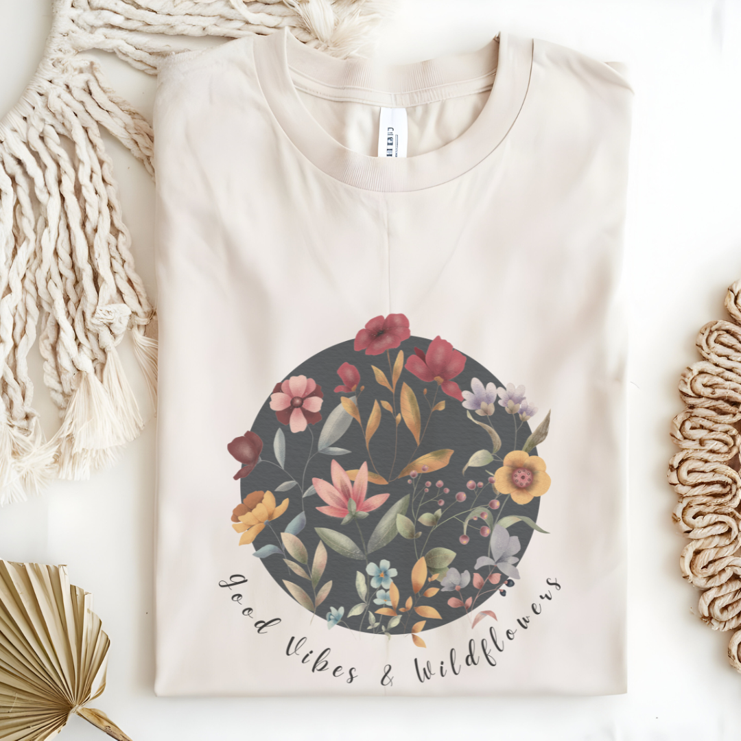 Flat lay of the "Hello Spring: Good Vibes & Wildflowers" Tee, highlighting the soft, 100% US cotton fabric, classic crew neck, and the beautiful botanical floral design.