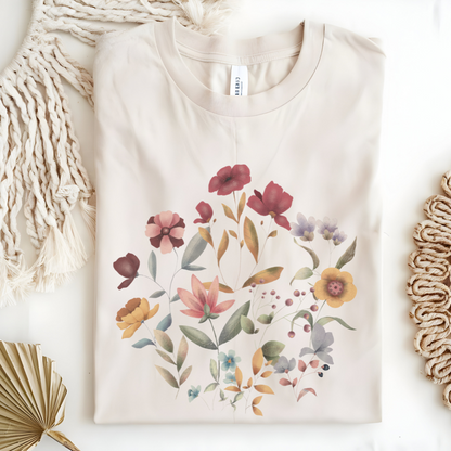 Flat lay of the "Hello Spring" Floral Tee, highlighting the soft, 100% US cotton fabric, classic crew neck, and the beautiful botanical floral design. Color Natural