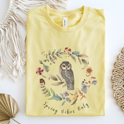 Flat lay of the "Spring Vibes Only" Tee, highlighting the soft, 100% US cotton fabric, classic crew neck, and the adorable owl and floral wreath design.  Color Cornsilk