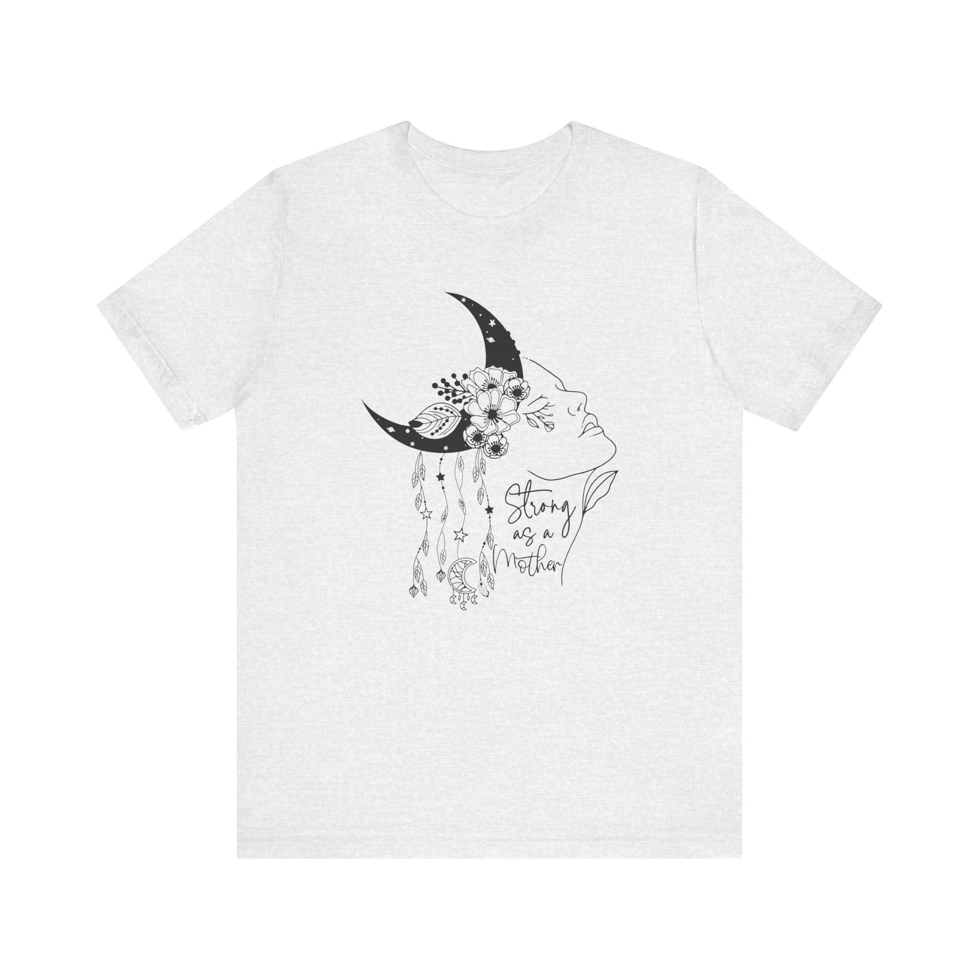 Flat lay of the "Strong as a Mother" T-Shirt, highlighting the soft Airlume cotton fabric and classic crew neckline. Color Ash. The graphic is clearly visible, showing the woman's profile, crescent moon, flowers, and charms in detail.