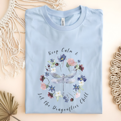 Flat lay of the "Chill Spring! Keep Calm & Let the Dragonflies Chill" T-Shirt, highlighting the soft, 100% ring-spun cotton fabric, classic crew neck, and the adorable dragonfly and floral wreath design. Color Light Blue
