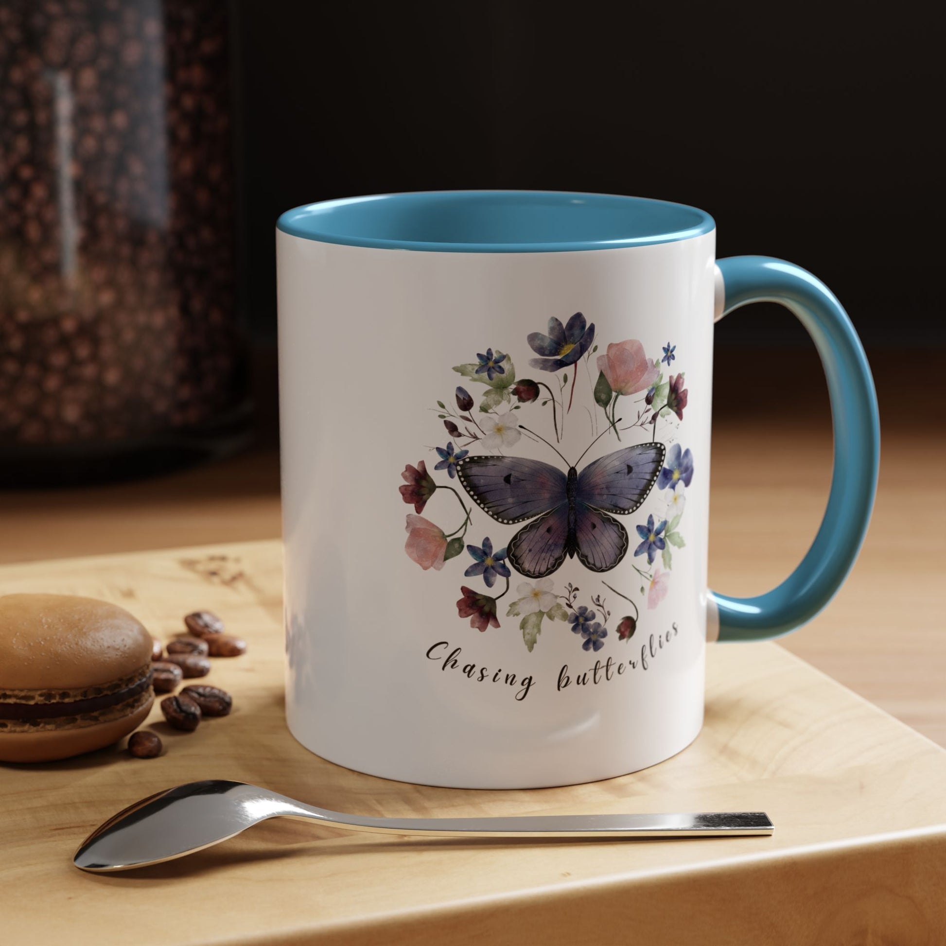 Close-up view of the intricate butterfly and wildflower design on the Butterfly & Wildflower Accent Coffee Mug, showcasing the vibrant colors and delicate details.