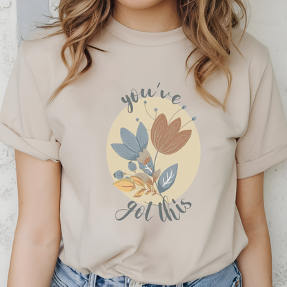  Cotton unisex t-shirt with "you've got this" motivational text and artistic floral design in blue, terracotta, and cream colors. Color sand