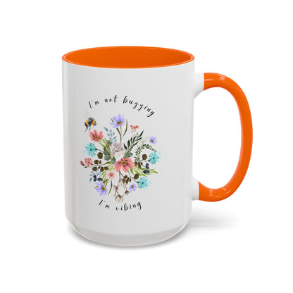 Close-up view of the detailed bee and wildflower illustration Coffee Mug,  15oz orange