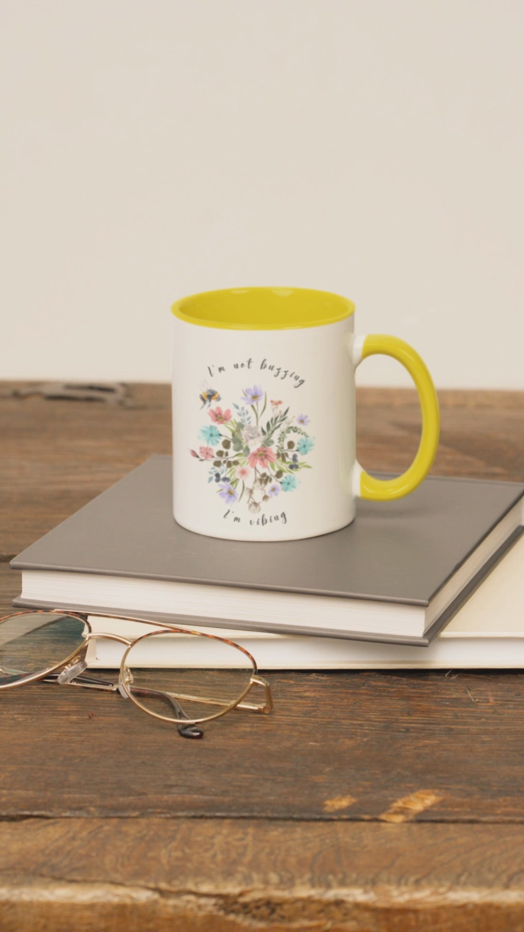  "I'm Not Buzzing, I'm Vibing" Bee & Wildflower Accent Coffee Mug, showcasing the charming bee and wildflower design on a white ceramic mug. Available in 11oz and 15oz sizes.
