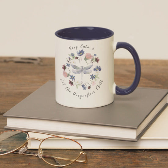 Keep Calm & Let Dragonflies Chill Coffee Mug, featuring a charming design of dragonflies and wildflowers on a white ceramic mug. Available in 11oz and 15oz.