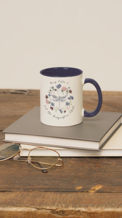Keep Calm & Let Dragonflies Chill Coffee Mug, featuring a charming design of dragonflies and wildflowers on a white ceramic mug. Available in 11oz and 15oz.